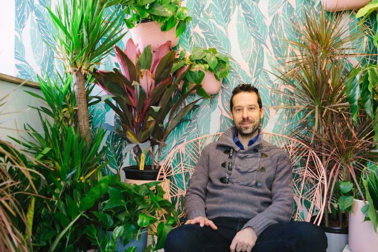 Vladan Nikolic (Mr. Houseplant) is sitting and the plants are in the background